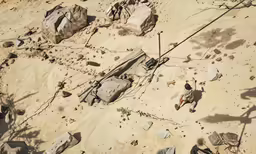 the view of rocks, gravel, and barbed wire