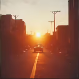 a car driving on the road into the sun