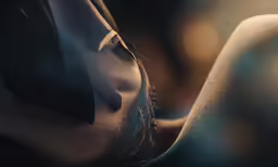 the naked girl with her head near her face