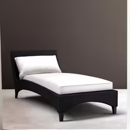 a white and black couch with a pillow