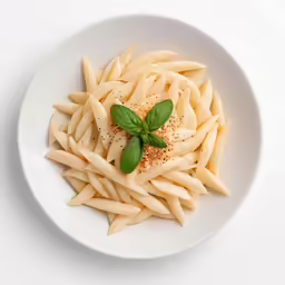 some pasta is on a plate with pepper