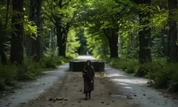 a woman stands alone on the side of a dirt road