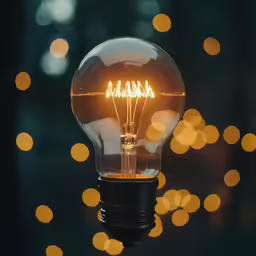 a light bulb is hanging from a string on a pole