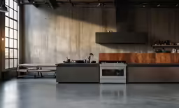 the inside of a kitchen with a counter, stove and refrigerator