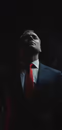 a man in a suit and tie is standing