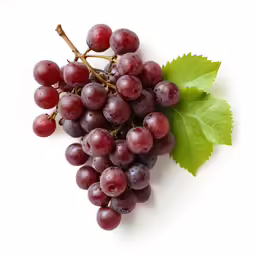 a bunch of grapes on top of a white surface