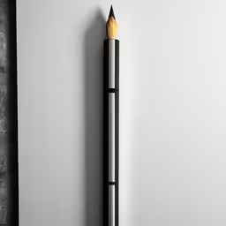 a pencil in the corner with a white wall