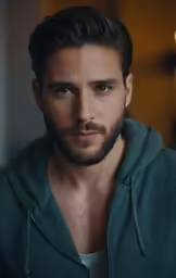 a male with a goatee and beard looking at the camera