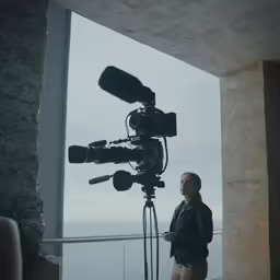 woman in front of camera looking through window