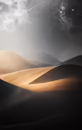 a night sky with stars above sand dunes