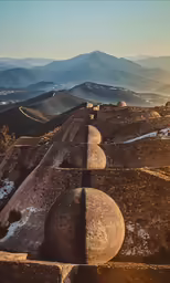 a hill with rocks and mountains on top
