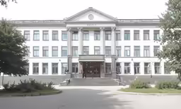 a building with many windows and trees outside