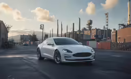 the white luxury car is traveling down the city road