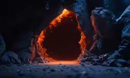 two people are using a cellphone while in front of a stone tunnel