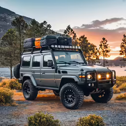 a gray land rover vehicle with bright lights on