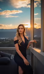 a beautiful blond in a black dress posing for a photo