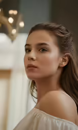a girl with long hair, looking at the camera