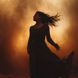 a woman is running along with her long hair in the wind
