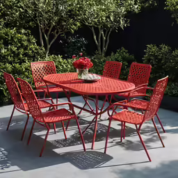 an outdoor table that has many chairs around it