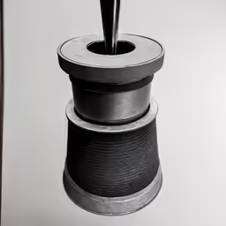 some sort of object being held in place in front of a mirror