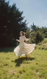 a woman in a dress is dancing in a field