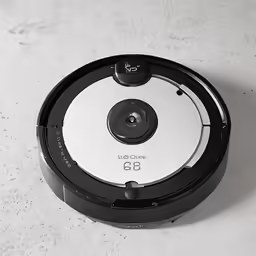 a robot on the floor with a white background