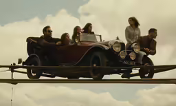 a group of people sitting on the front of a car