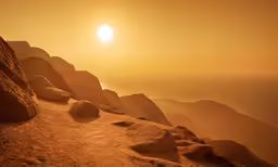 the sun setting on the top of a mountain