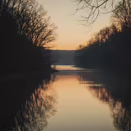 the water is very calm at sunset time