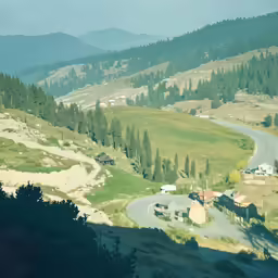a winding road going through the mountains in the day