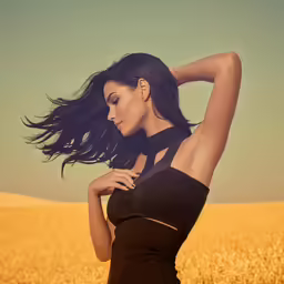 a young beautiful woman posing in a field