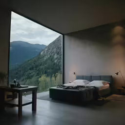 a bedroom with mountain view with a bed made up