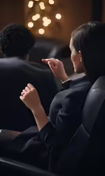 two people looking at the screen while sitting in a theater