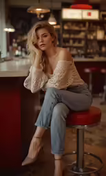 a beautiful young woman sitting on top of a red stool