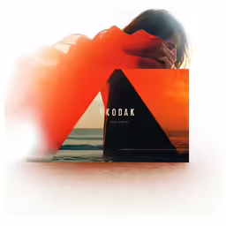 a woman poses next to a krodak bottle on a beach