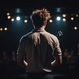 a man in dark room with some lights on
