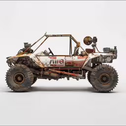 a car with four wheels and big tires is made from steel,this is an old dirty car made of wheels