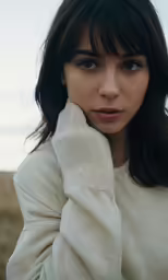 the woman with black hair is sitting down