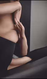 a nude girl with a black top posing for a photo
