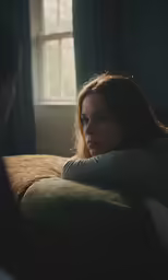there is a woman that is laying down with her head on a pillow