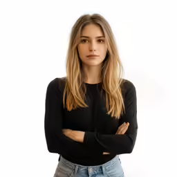a woman in jeans and black top posing for a picture
