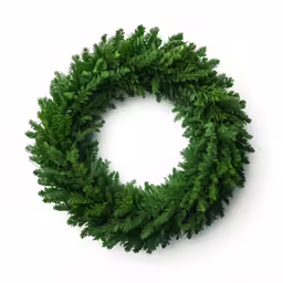 a close up of a green wreath with leaves