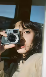 a woman takes a photo in front of a window