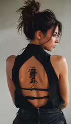 woman with asian ink writing on her back