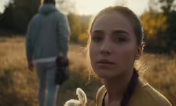 woman with braid hair and a dog standing in front of a man