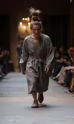 a female model is walking down the runway