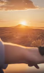 a sunset view from an airplane of some hills