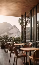 chairs and tables overlooking the landscape on top of a mountain