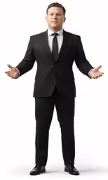 a man in a suit and tie standing with his hands open