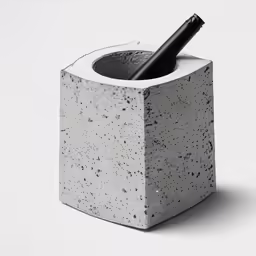 an object is made out of cement with a pen in the middle